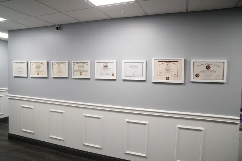 Wall of degrees at Alabama Surgical Arts