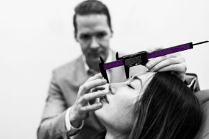 Dr. Sami A Nizam measuring a patient's face