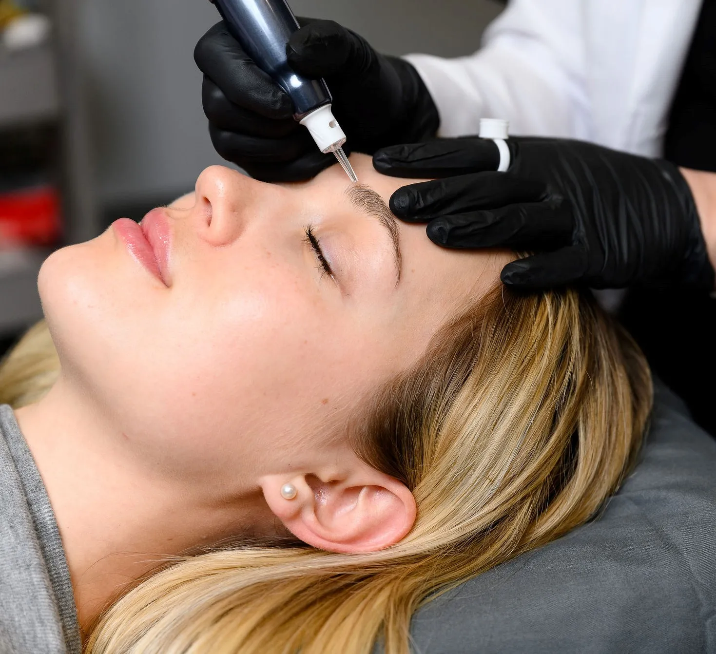 Woman receiving permanent cosmetic tattoos 