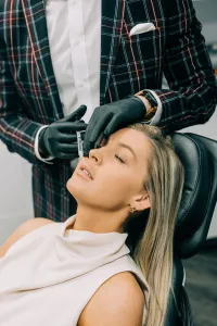 Woman receiving a facial filler injection