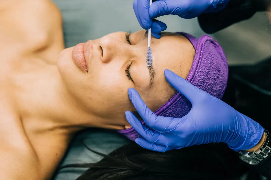 Woman receiving eyebrow treatment